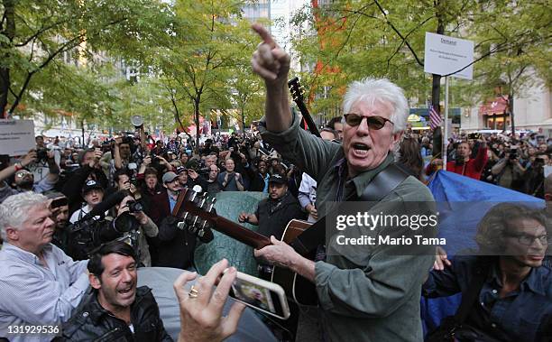 Musician Graham Nash yells to the crowd after he and David Crosby played an acoustic set for members of Occupy Wall Street in Zuccotti Park on...