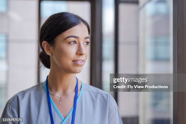 wondering what tomorrow will bring - female nurse stock pictures, royalty-free photos & images