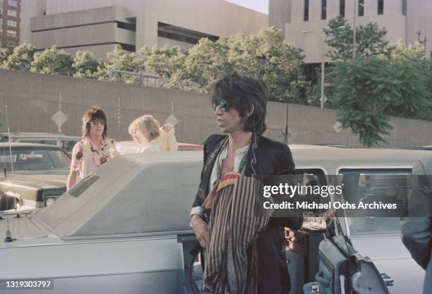 British guitarist and songwriter Keith Richards, wearing a jacket with embroidered ​embellishment on the lapels and aviator sunglasses with mirrored...