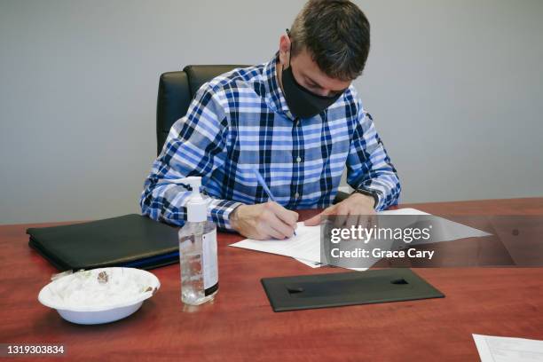 man signs paperwork in conference room - real estate closing stock pictures, royalty-free photos & images