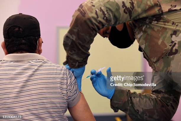 Maryland National Guard Sgt. Jason Grant administers a Moderna coronavirus vaccine at CASA de Maryland's Wheaton Welcome Center on May 21, 2021 in...