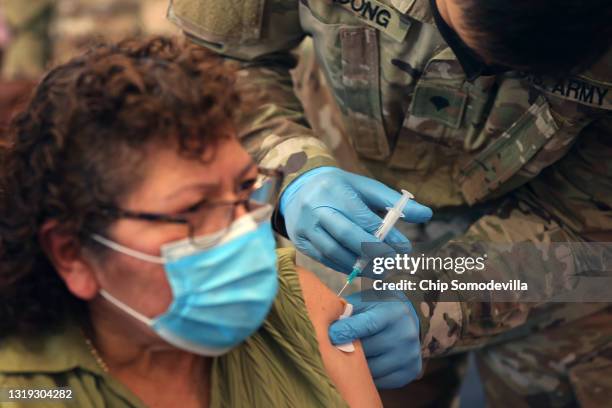 Maryland National Guard Specialist James Truong administers a Moderna coronavirus vaccine at CASA de Maryland's Wheaton Welcome Center on May 21,...