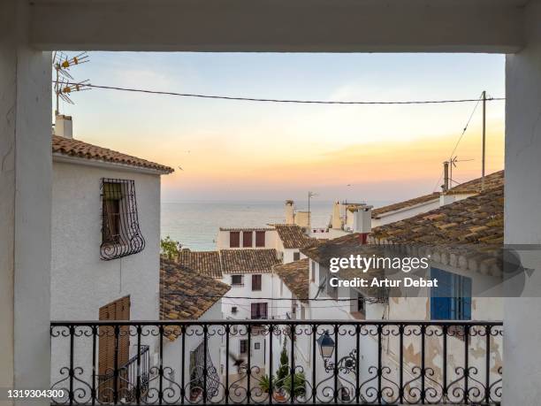 beautiful view of spanish white town in alicante coast during sunset. vista de el pueblo de altea en alicante durante atardecer en verano. - alicante street stock pictures, royalty-free photos & images