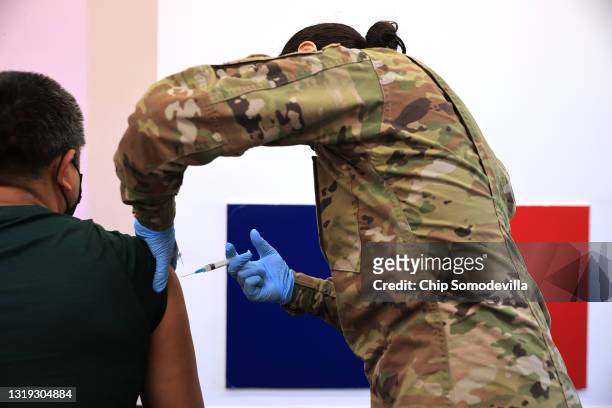 Maryland National Guard PFC Keiry Pearla administers a Moderna coronavirus vaccine at CASA de Maryland's Wheaton Welcome Center on May 21, 2021 in...
