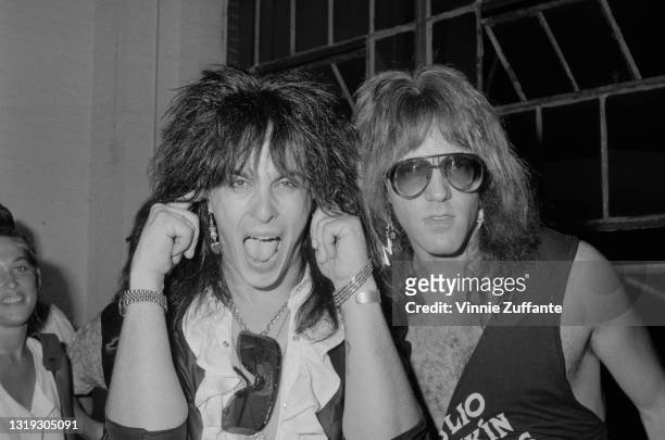 American bass player Nikki Sixx of American glam metal band Motley Crue, with his fingers in his ears, and American guitarist Jay Jay French of...