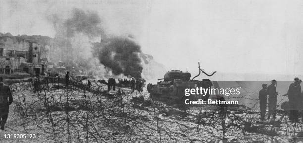 Wrecked allied tanks and trucks on the beach at Dieppe after the Dieppe Raid. The Dieppe Raid took place on August 19, 1942. The raid was a failure,...