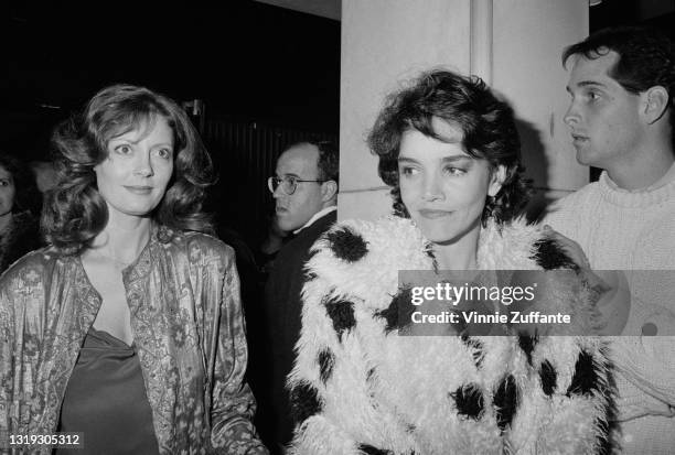 American actress Susan Sarandon, wearing a silk jacket, and American actress Brooke Adams, wearing a shaggy white fur coat with black spots,...