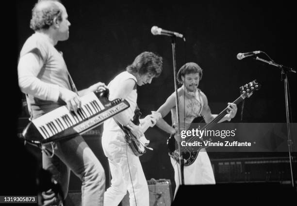 Czech-American musician and composer Jan Hammer playing keyboards supported on a shoulder strap, British guitarist and songwriter Jeff Beck, wearing...