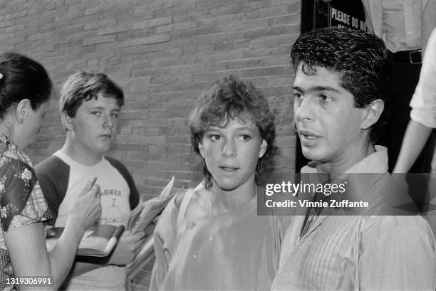 American actress and comedian Kristy McNichol with hairdresser Joey Corsaro, unspecified people waiting in the background, location unspecified,...