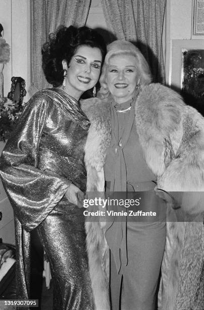American actress, singer and dancer Ann Miller , wearing a lam� evening gown with a cowl neck and bell sleeves, and American actress, singer and...