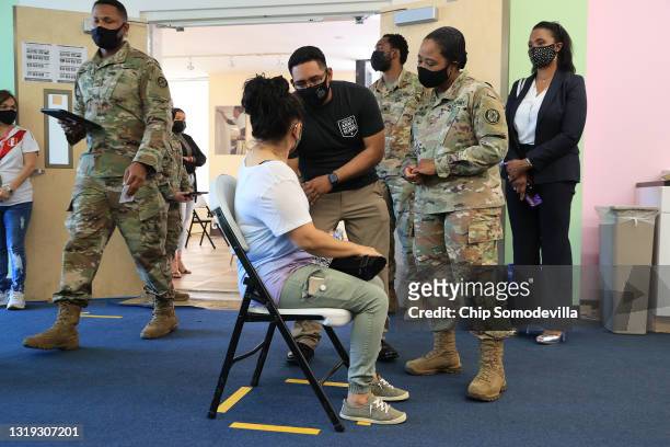 Maryland National Guard Brigadier General Janeen Birckhead visits with a woman after she received her Moderna coronavirus vaccine with the help of...