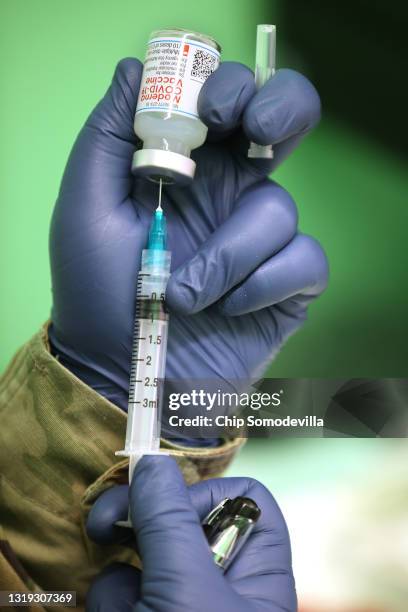 Maryland National Guard PFC Caitlyn Conver fills a syringe with a dose of the Moderna coronavirus vaccine during a clinic at CASA de Maryland's...