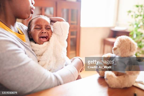 loving young mother consoling her crying little girl - tantrum stock pictures, royalty-free photos & images