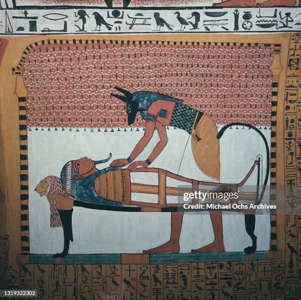 Fresco on the tomb of Sennedjem, among the Tombs of the Nobles, depicting the god Anubis, guardian of the dead, performing the mummification of in...