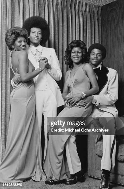 Unspecified models wearing tuxedos with ruffled shirts, and evening gowns during a fashion shoot for 'Right On!' magazine in New York City, New York,...