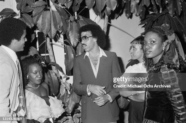 American actor Phil Morris, with an unspecified woman, American singer, songwriter and musician Lionel Richie, Hazel Gordy, and Brenda Harvey-Richie...