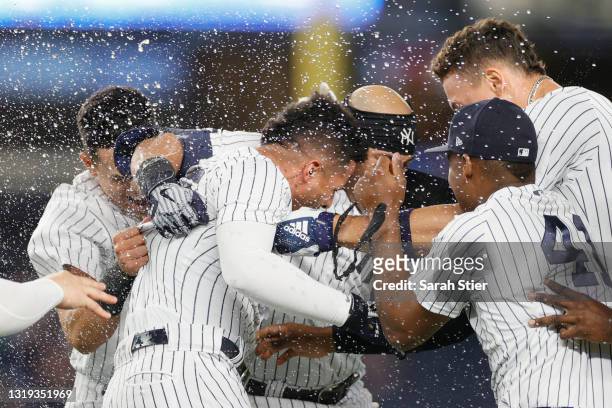 Aaron Judge, Miguel Andujar, Rougned Odor, and Gio Urshela celebrate with Gleyber Torres of the New York Yankees after his walk-off RBI single during...