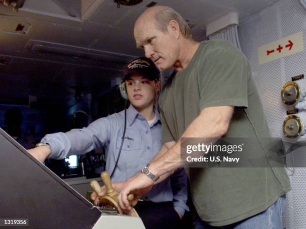 Seaman Blair C. Mammel from Billings, Montana, explains her duties as Ship''s Helmsman to television sportscaster and former Pittsburgh Steelers...