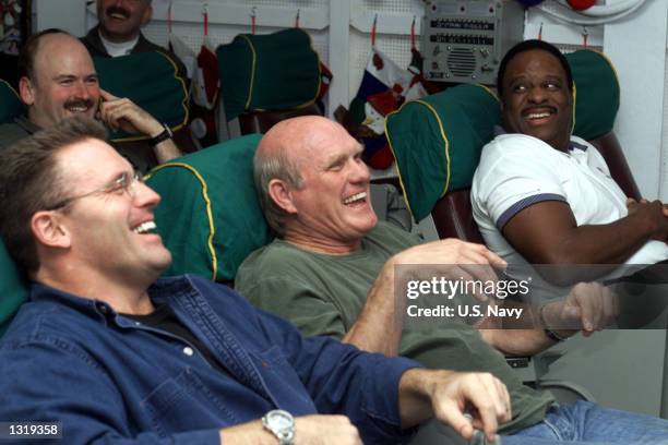 Left to right, network television sportscasters Howie Long, Terry Bradshaw, and James Brown share a laugh during a flight briefing December 14, 2000...