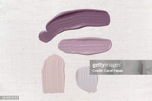 purple and pink paint smears in beige background.top view - grey colour stockfoto's en -beelden