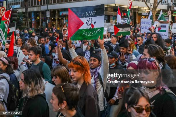 General view of Pro-Palestinian protesters holding placards as they march during a Rally on May 22, 2021 in Melbourne, Australia. Rallies were...