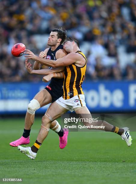 Lachie Plowman of the Blues and Jaeger O'Meara of the Hawks collide going for a mark during the round 10 AFL match between the Carlton Blues and the...