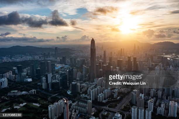 skyline of shenzhen city, guangdong province, china, with sunlight shining on high-rise buildings - shenzhen stock pictures, royalty-free photos & images