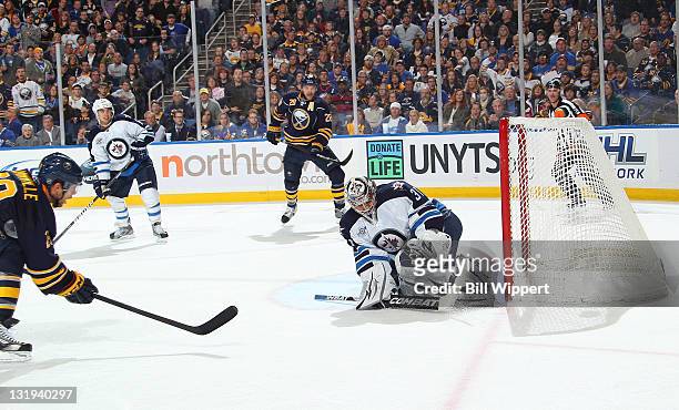 Jason Pominville of the Buffalo Sabres scores a first period shorthand goal against Ondrej Pavelec of the Winnipeg Jets on a pass from teammate Paul...