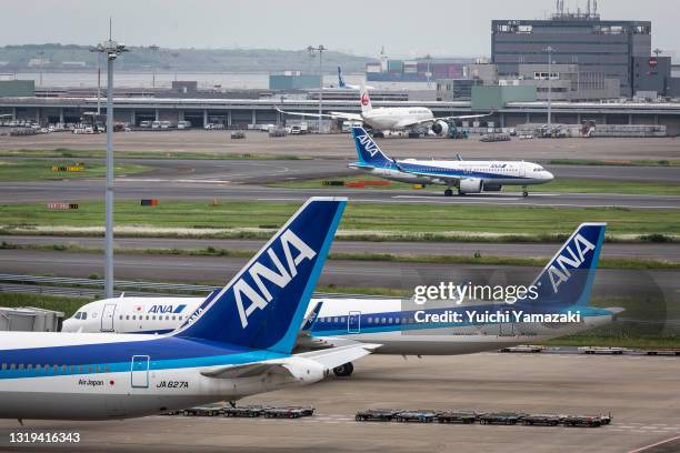 All Nippon Airways airplanes are seen at Haneda Airport on May 22, 2021 in Tokyo, Japan. The Japanese government recently announced that it will add...