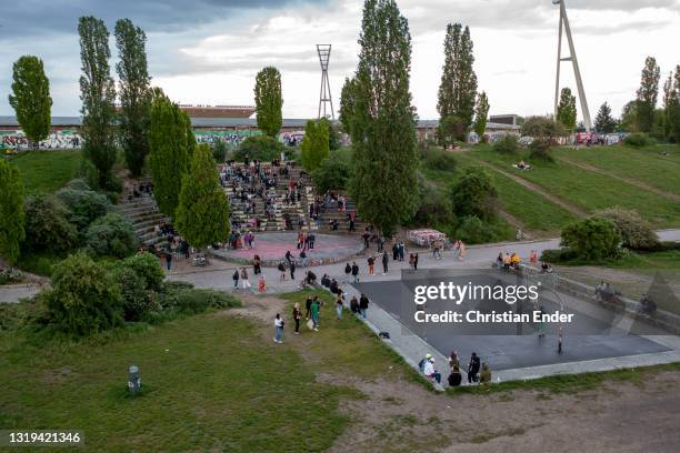 In an aerial view, young people relax and play basketball at Mauerpark in Prenzlauer Berg district at sunset during the coronavirus pandemic on May...