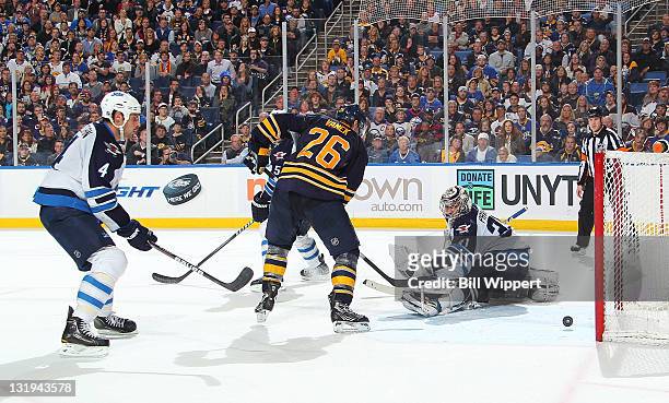 Thomas Vanek of the Buffalo Sabres scores the game winning overtime goal against Ondrej Pavelec of the Winnipeg Jets at First Niagara Center on...