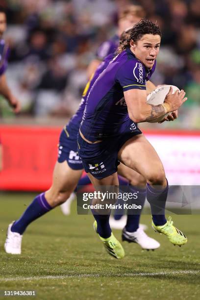 Nicho Hynes of the Storm makes a break during the round 11 NRL match between the Canberra Raiders and the Melbourne Storm at GIO Stadium, on May 22...