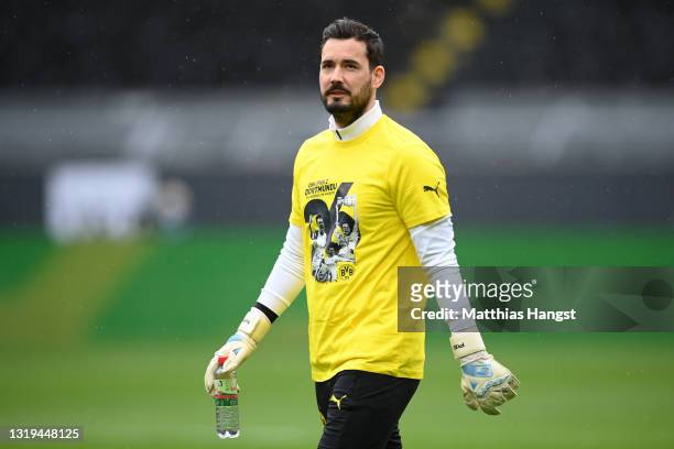 Roman Buerki of Borussia Dortmund wearing a shirt as a tribute to Lukasz Piszczek of Borussia Dortmund ahead of his last game for the club during the...