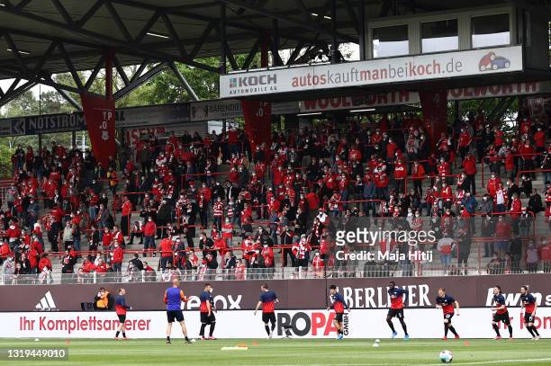 Fans watch on from the stand prior to the Bundesliga match between 1. FC Union Berlin and RB Leipzig at Stadion An der Alten Foersterei on May 22,...