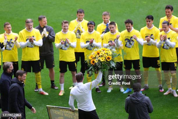 Lukasz Piszczek of Borussia Dortmund is presented with flowers ahead of his last game for the club during the Bundesliga match between Borussia...