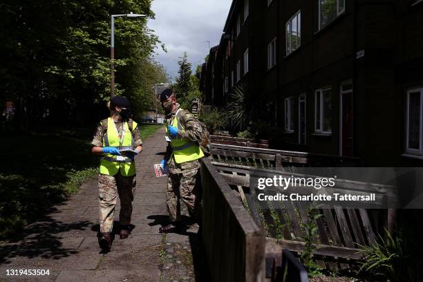 Members of the Armed Forces distribute Covid-19 leaflets to local residents of Halliwell on May 22, 2021 in Bolton, England. The Covid-19 B.1.617.2...