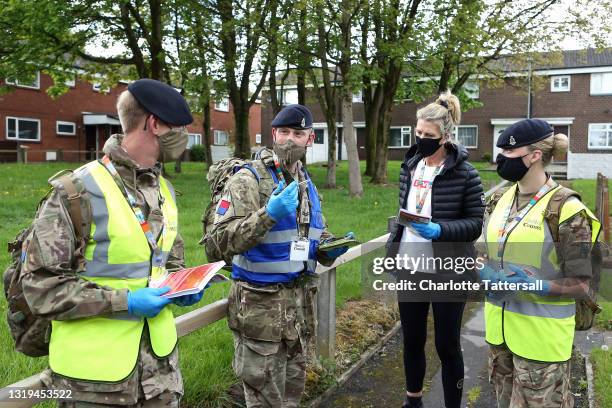 Members of the Armed Forces make a checklist of streets where Covid-19 leaflets have been distributed to local residents of Halliwell on May 22, 2021...