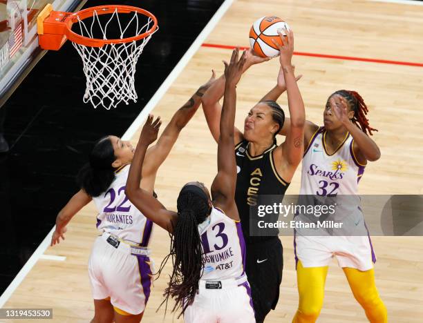 Liz Cambage of the Las Vegas Aces shoots against Arella Guirantes, Chiney Ogwumike and Bria Holmes of the Los Angeles Sparks during their game at...