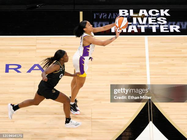 Arella Guirantes of the Los Angeles Sparks shoots from near half court as the shot clock expires against Jackie Young of the Las Vegas Aces during...
