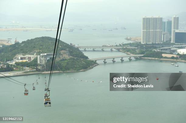 view from cable car descending into tung chung from tian tan buddha statue complex. lantau island, hong kong, china - by sheldon levis stock pictures, royalty-free photos & images