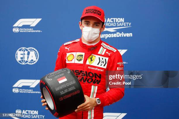 Pole position qualifier Charles Leclerc of Monaco and Ferrari poses with his pole position award in parc ferme during qualifying prior to the F1...
