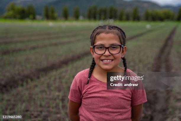 portrait of a latin american girl smiling at a farm - poverty girl stock pictures, royalty-free photos & images