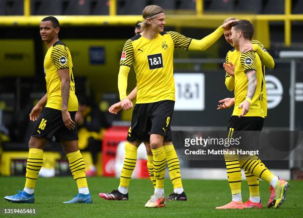 Marco Reus of Borussia Dortmund celebrates with teammates Erling Haaland and Julian Brandt after scoring his team's second goal during the Bundesliga...
