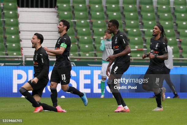 Ramy Bensebaini of Borussia Moenchengladbach celebrates after scoring their team's third goal Lars Stindl, Denis Zakaria and Valentino Lazaro during...