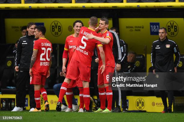 Sven Bender of Bayer Leverkusen interacts with Lars Bender of Bayer Leverkusen as he comes off after his last match for the club during the...