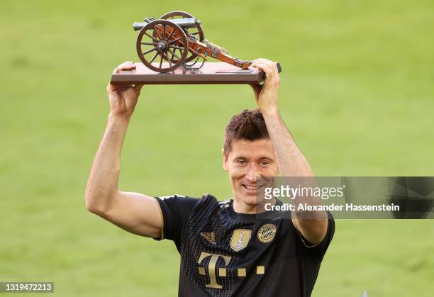 Robert Lewandowski of FC Bayern Muenchen raises the top goalscorer of the season award following the Bundesliga match between FC Bayern Muenchen and...