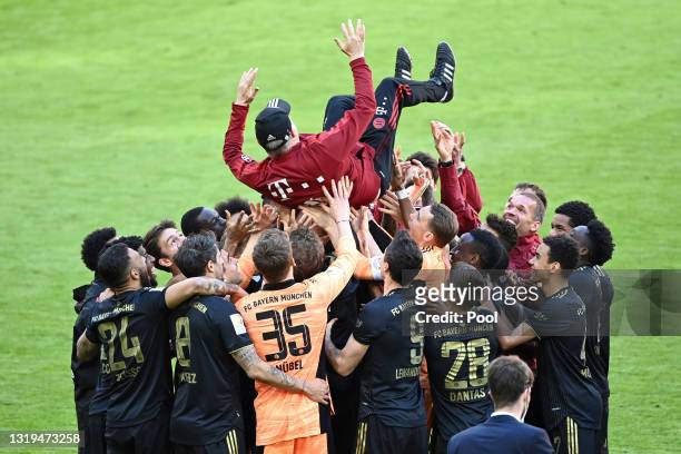 Hermann Gerland, Assistant Coach of FC Bayern Muenchen is lifted in the air by the FC Bayern Muenchen players following the Bundesliga match between...