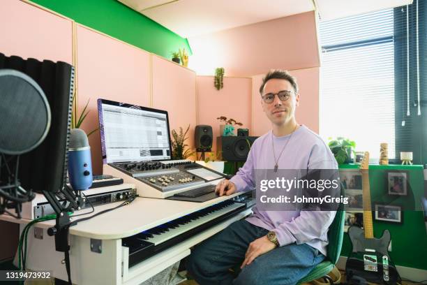 portrait of musician at console in home recording studio - sound engineer stock pictures, royalty-free photos & images