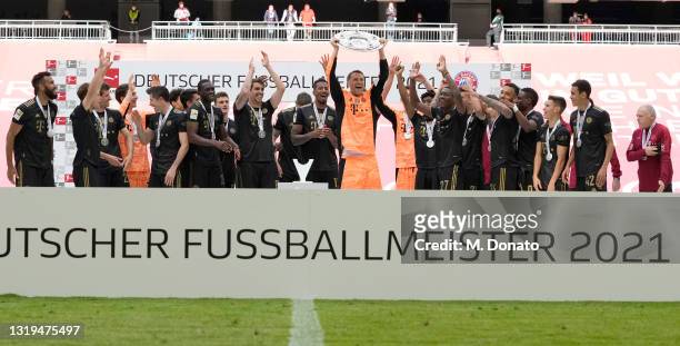 Team captain and goalkeeper Manuel Neuer of FC Bayern Muenchen lifts the German Championship trophy after the season's last Bundesliga match between...