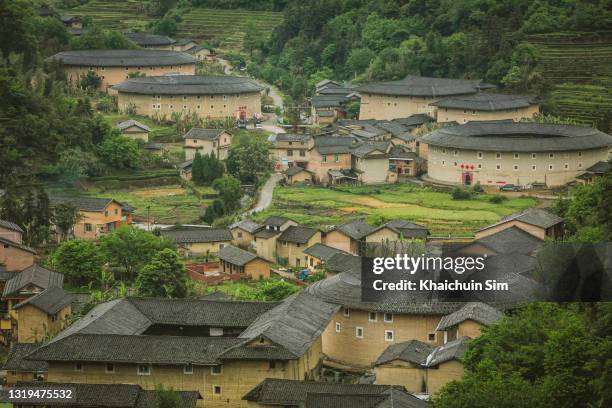 ariel view of fujian tulou in the mountains - fujian province stock pictures, royalty-free photos & images